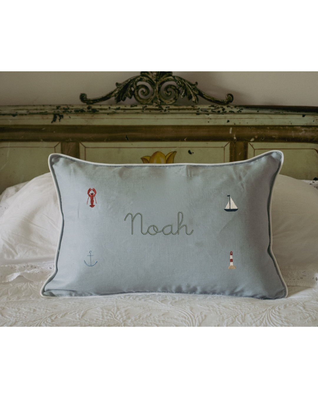 Duck egg blue gingham linen nautical cushion with embroidered sea-themed designs and personalized name Noah.