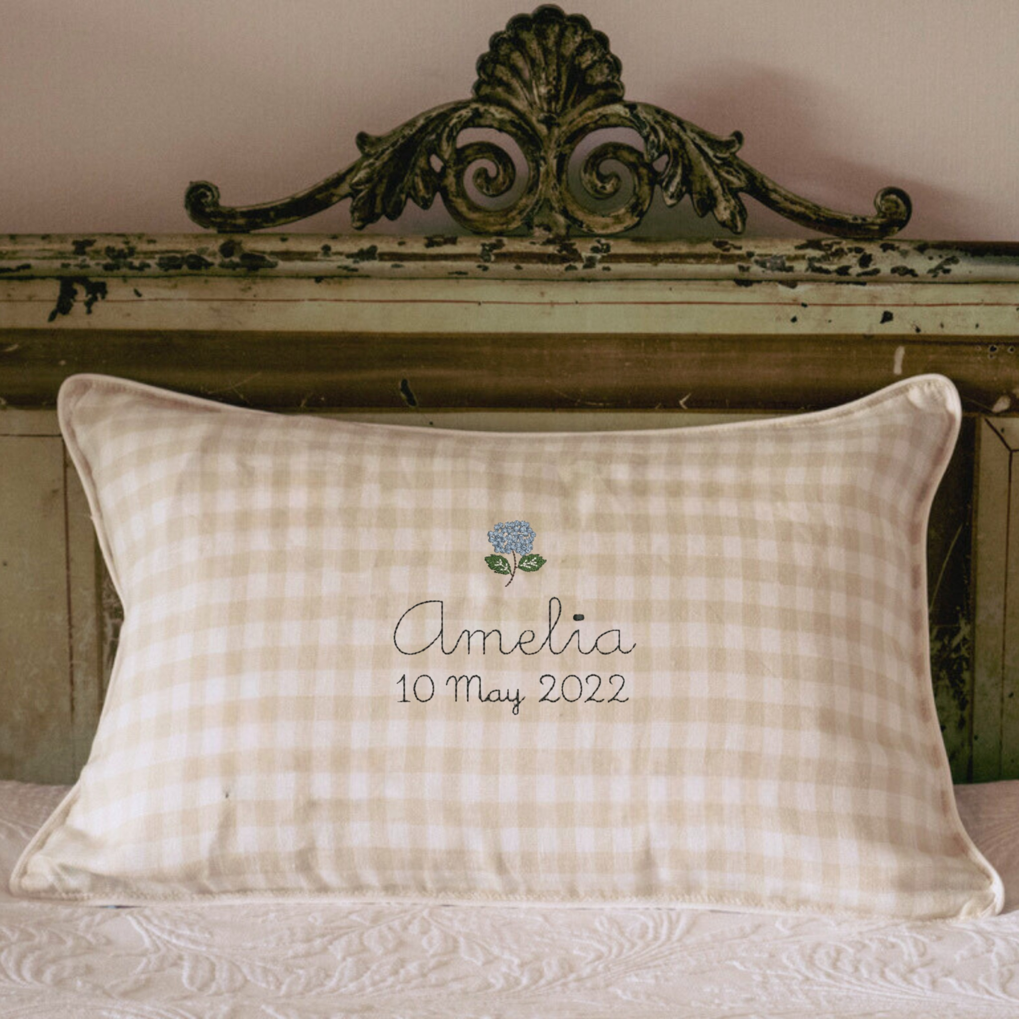 Hydrangea Linen Cushion with personalized embroidery on vintage bed.
