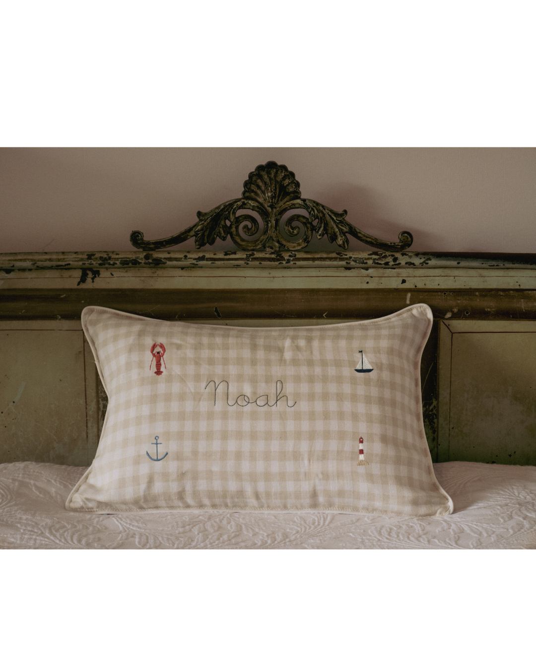 Nautical cushion with duck egg blue gingham linen, embroidered sea-themed designs and personalized name "Noah"