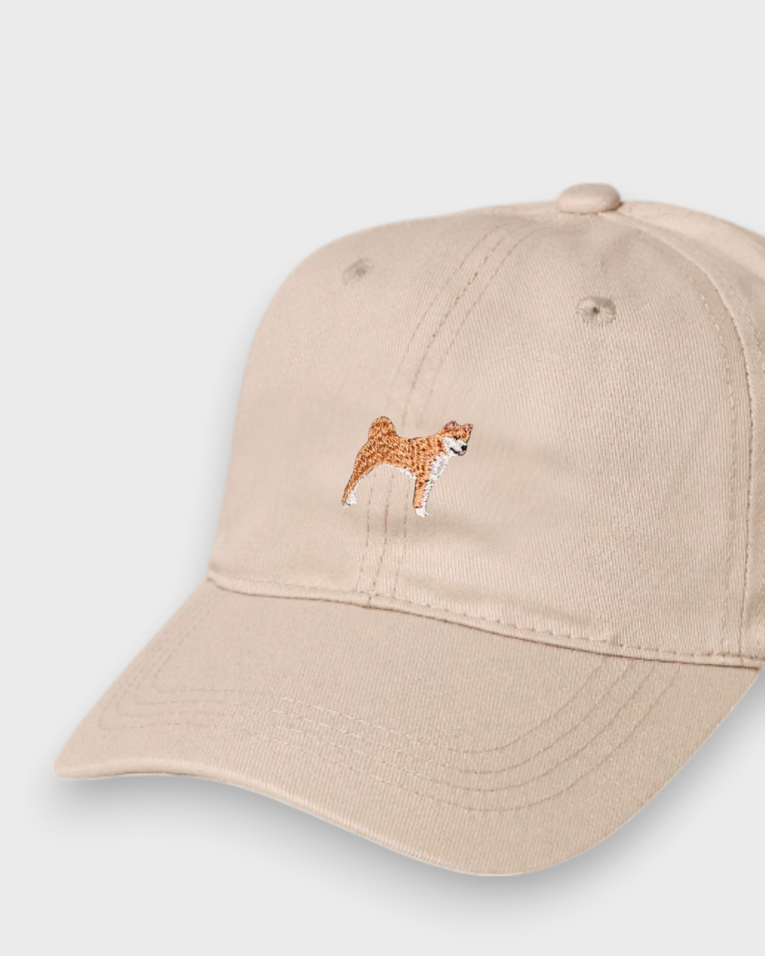 Beige baseball cap with embroidered Shiba Inu design, personalised embroidered text option, made of 100% washed cotton.