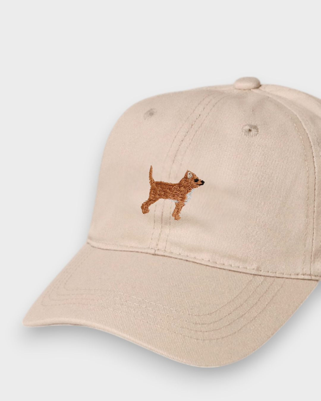 Beige personalised cotton baseball hat with embroidered brown dog design on front