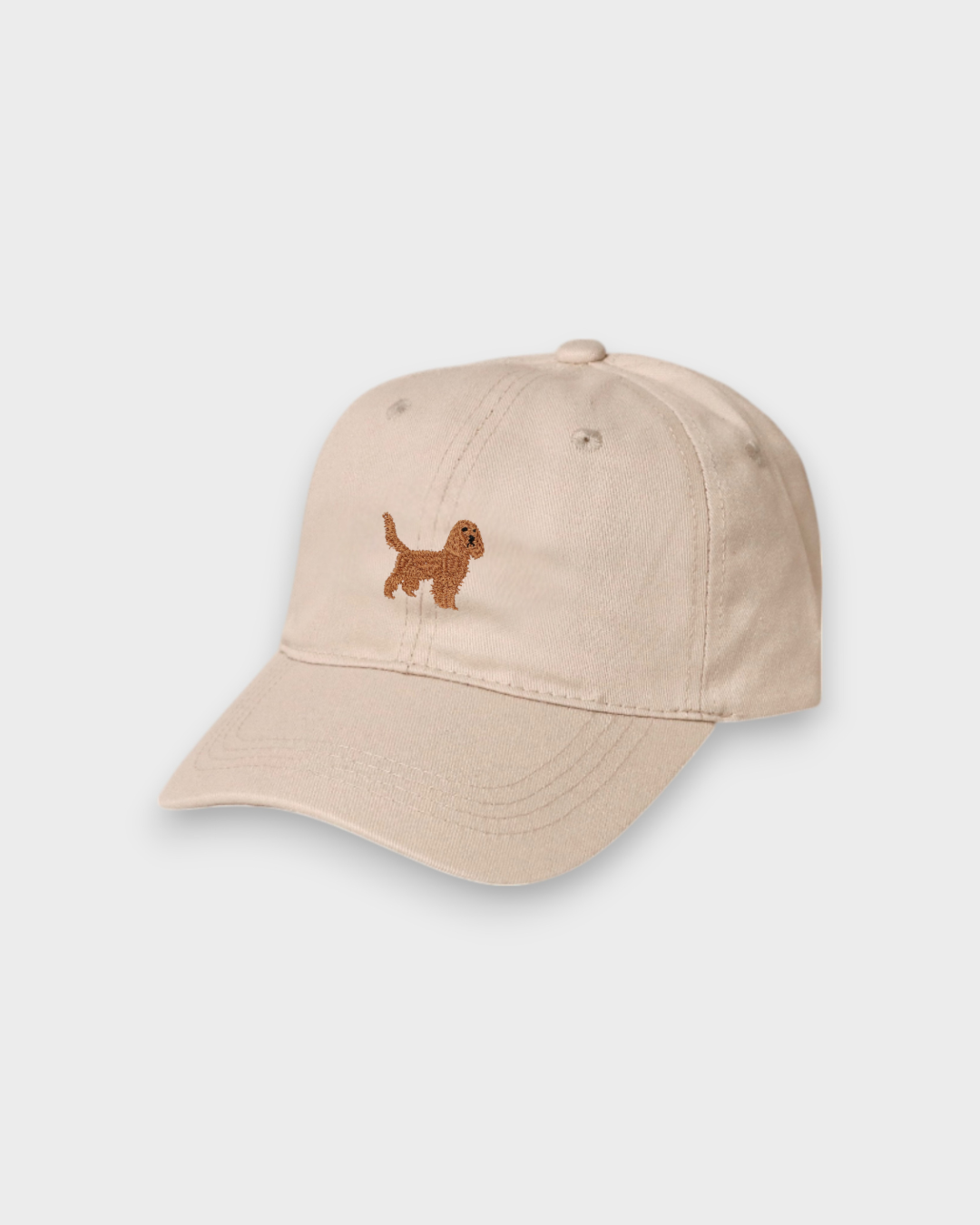 Beige Kelpie personalised hat with embroidered hand-drawn Cocker Spaniel design on front, classic baseball fit made of 100% washed cotton