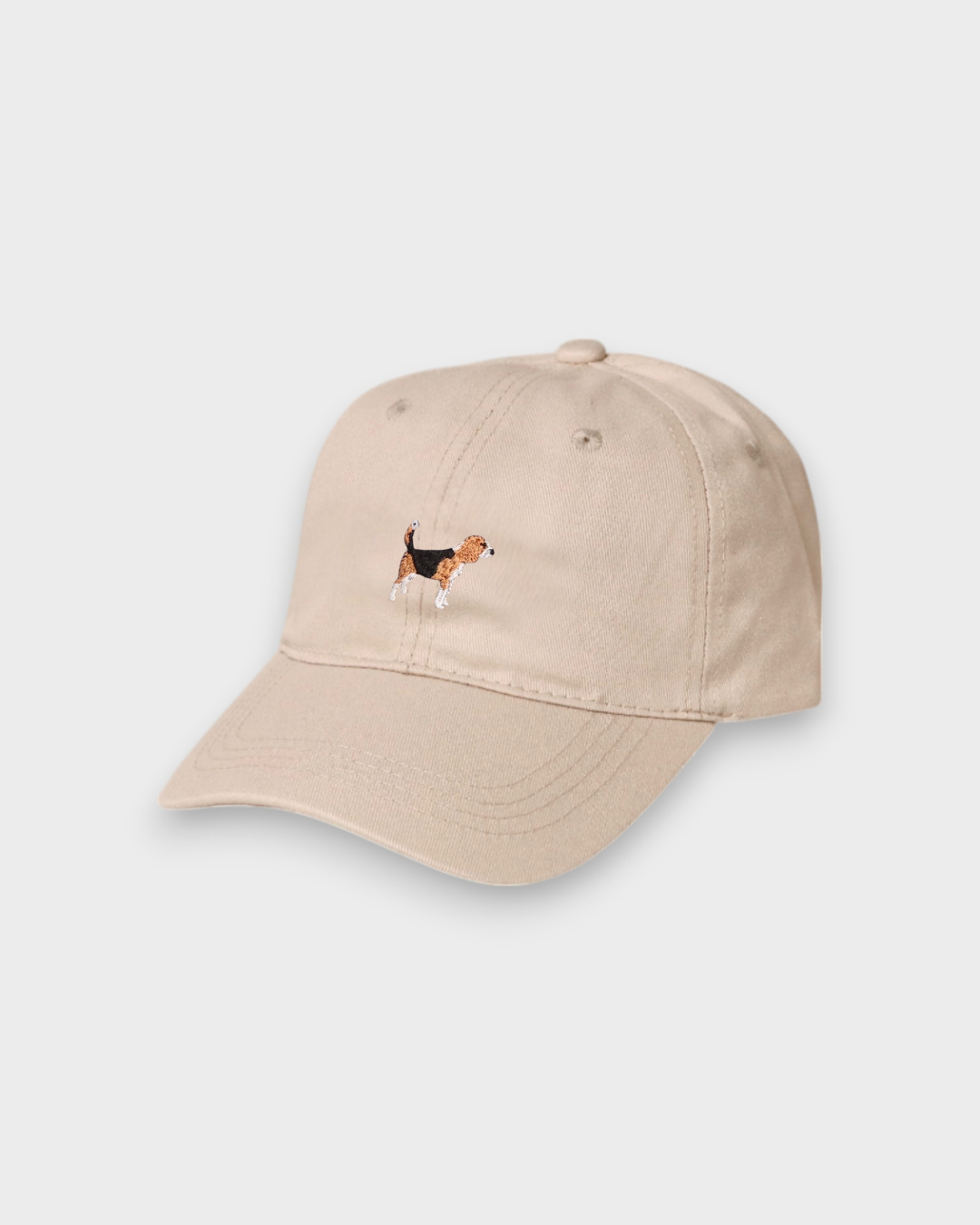 Beige baseball cap with hand-drawn embroidered Beagle design on front, personalised embroidery on back, made of 100% washed cotton.