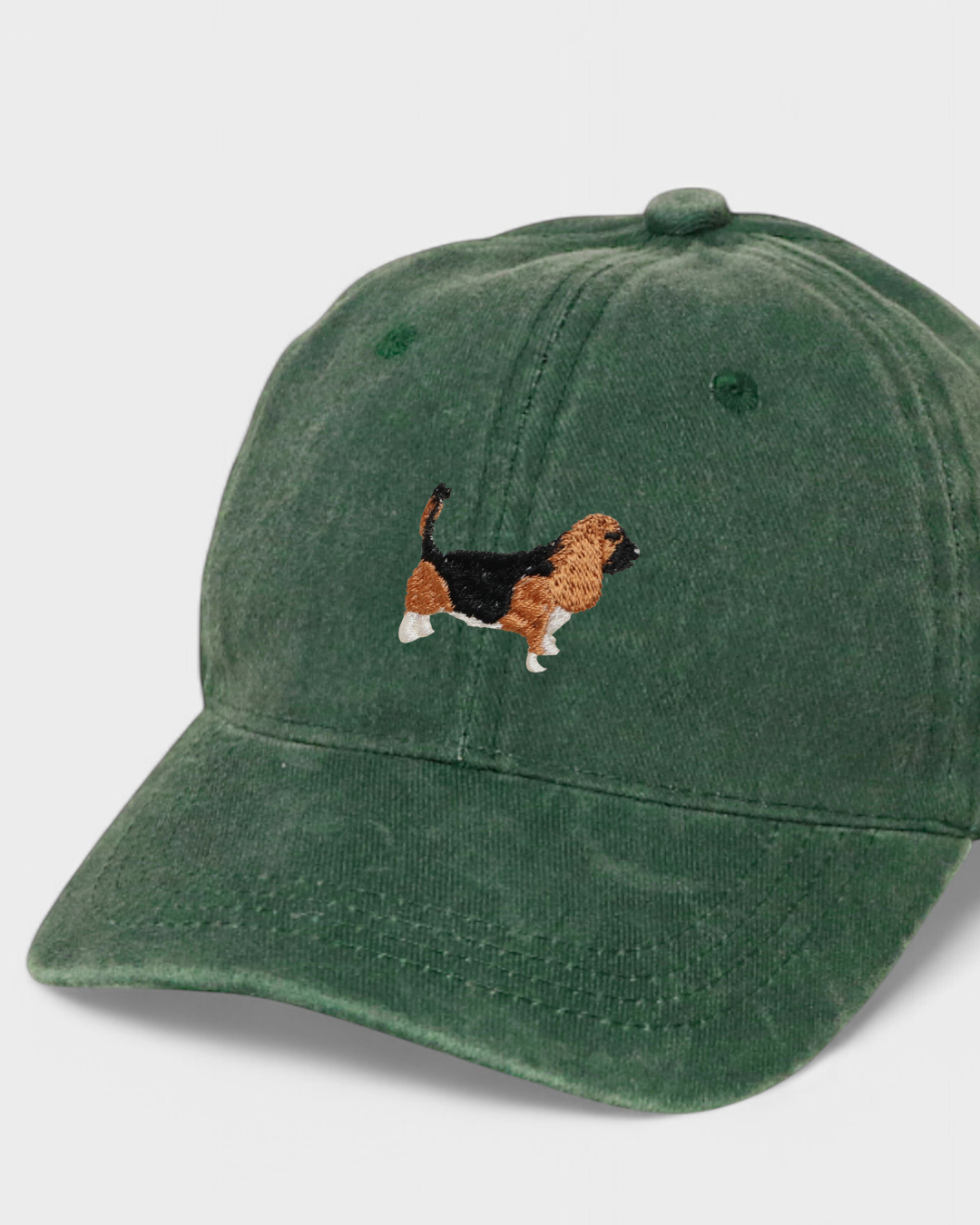 Green baseball cap with embroidered hand-drawn Basset Hound design, personalized back embroidery option, made of 100% washed cotton.