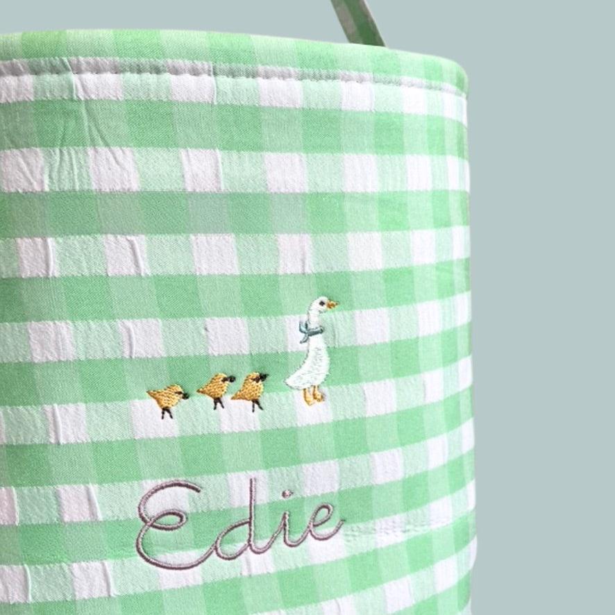 Personalised Easter Bucket with hand-drawn Mother Goose embroidery on green gingham pattern.