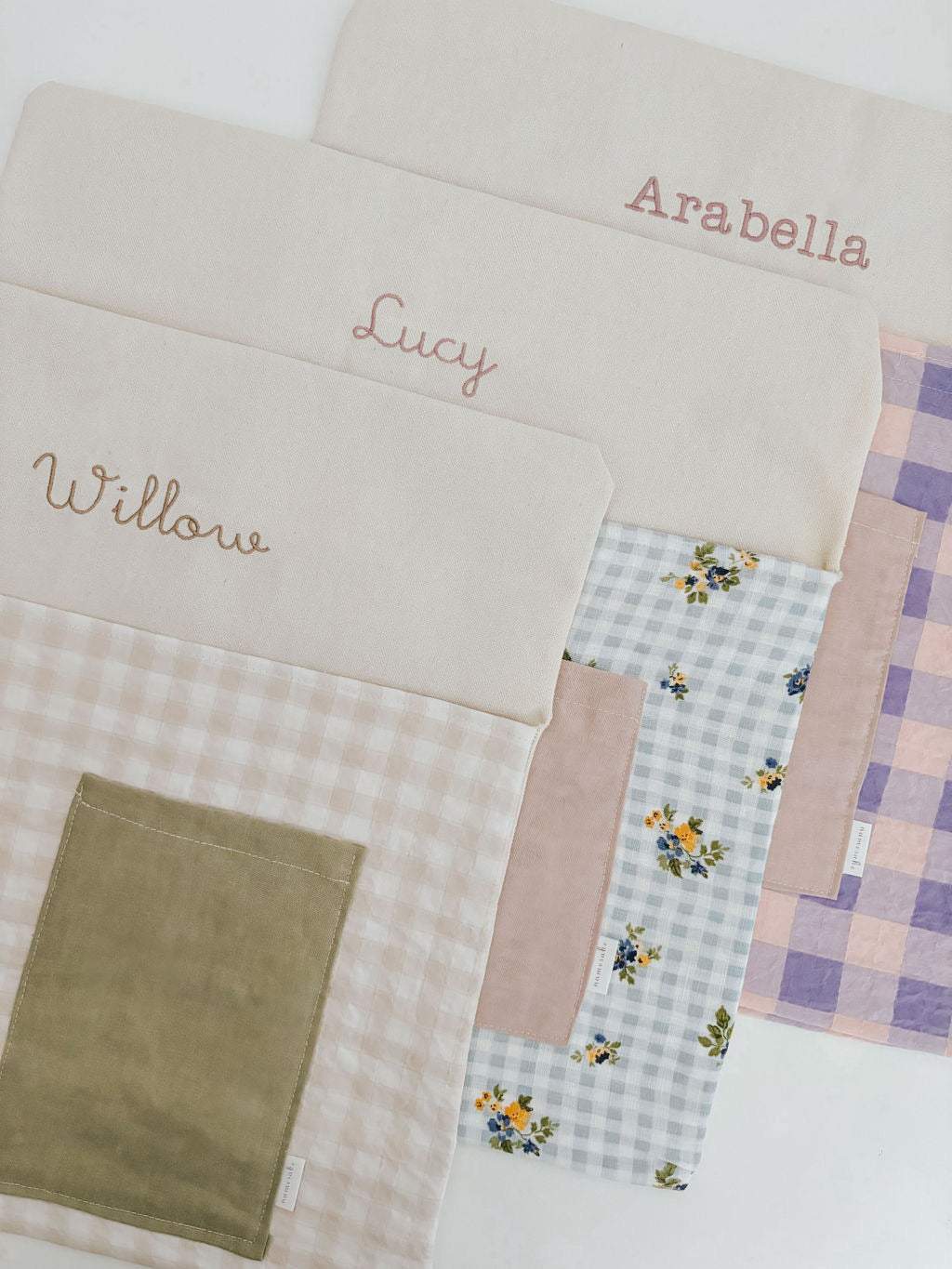 Personalised chair bags in floral gingham design, embroidered with children's names.