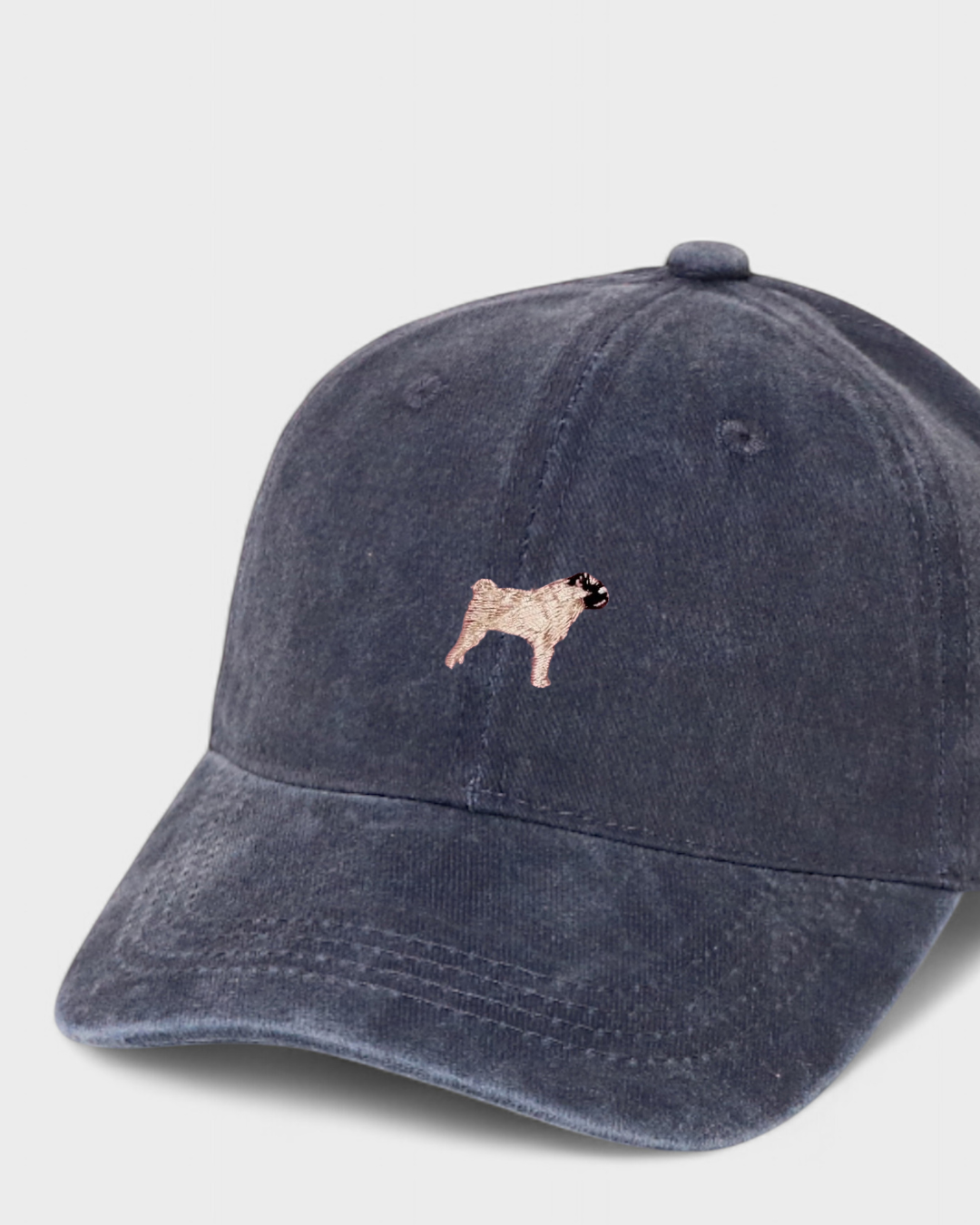 Navy washed cotton baseball cap with embroidered hand-drawn pug design, personalised embroidery option on the back.
