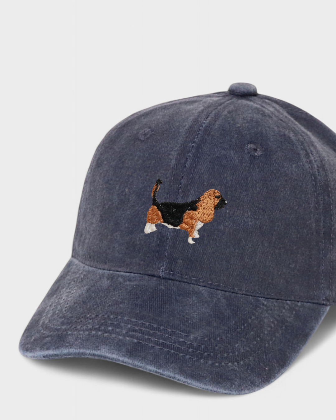 Navy washed cotton baseball hat with embroidered Basset Hound design and customizable back embroidery.