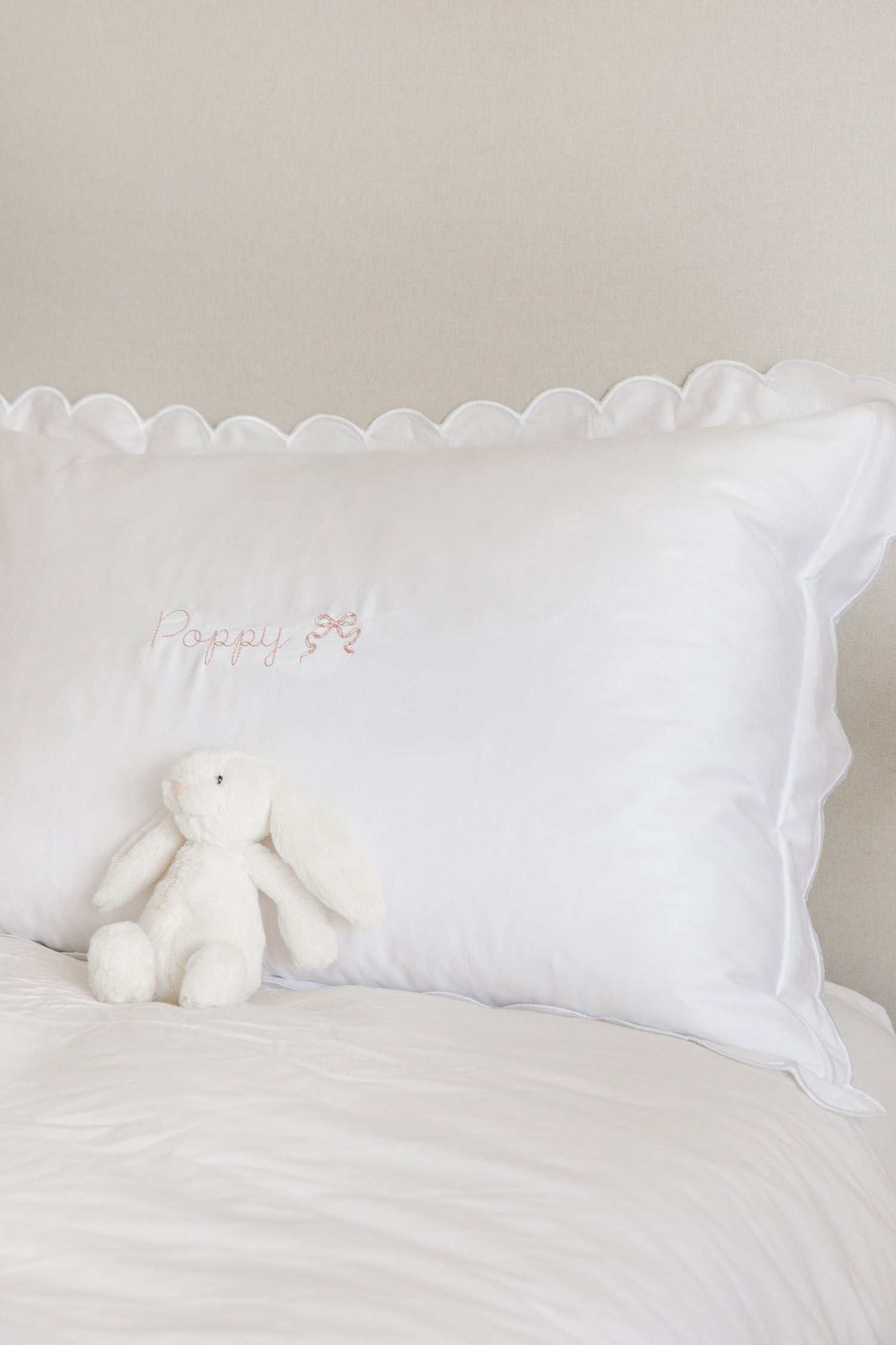 Organic cotton pillowcase with white scalloped edge and customizable embroidery.