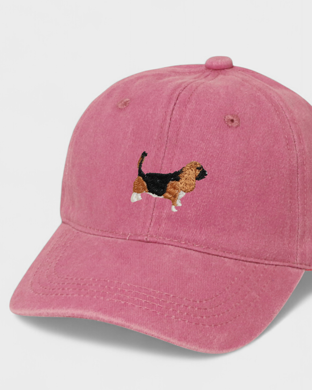 Pink baseball hat with embroidered Basset Hound design on front, personalised embroidery option on back, made of 100% washed cotton.
