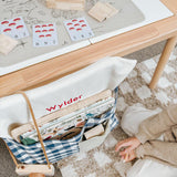 Blue gingham personalised chair bag on a children's chair with embroidery, ideal for organized learning spaces.