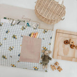 Personalised chair bag with floral gingham design, children's name embroidery, and stationery, promoting organized learning.