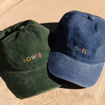 Personalised hat with multi-coloured embroidered text on washed cotton fabric.
