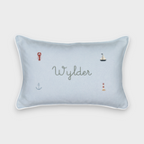 Nautical cushion in duck egg blue gingham linen with embroidered sea-themed designs and personalized name, white piping, removable cover.