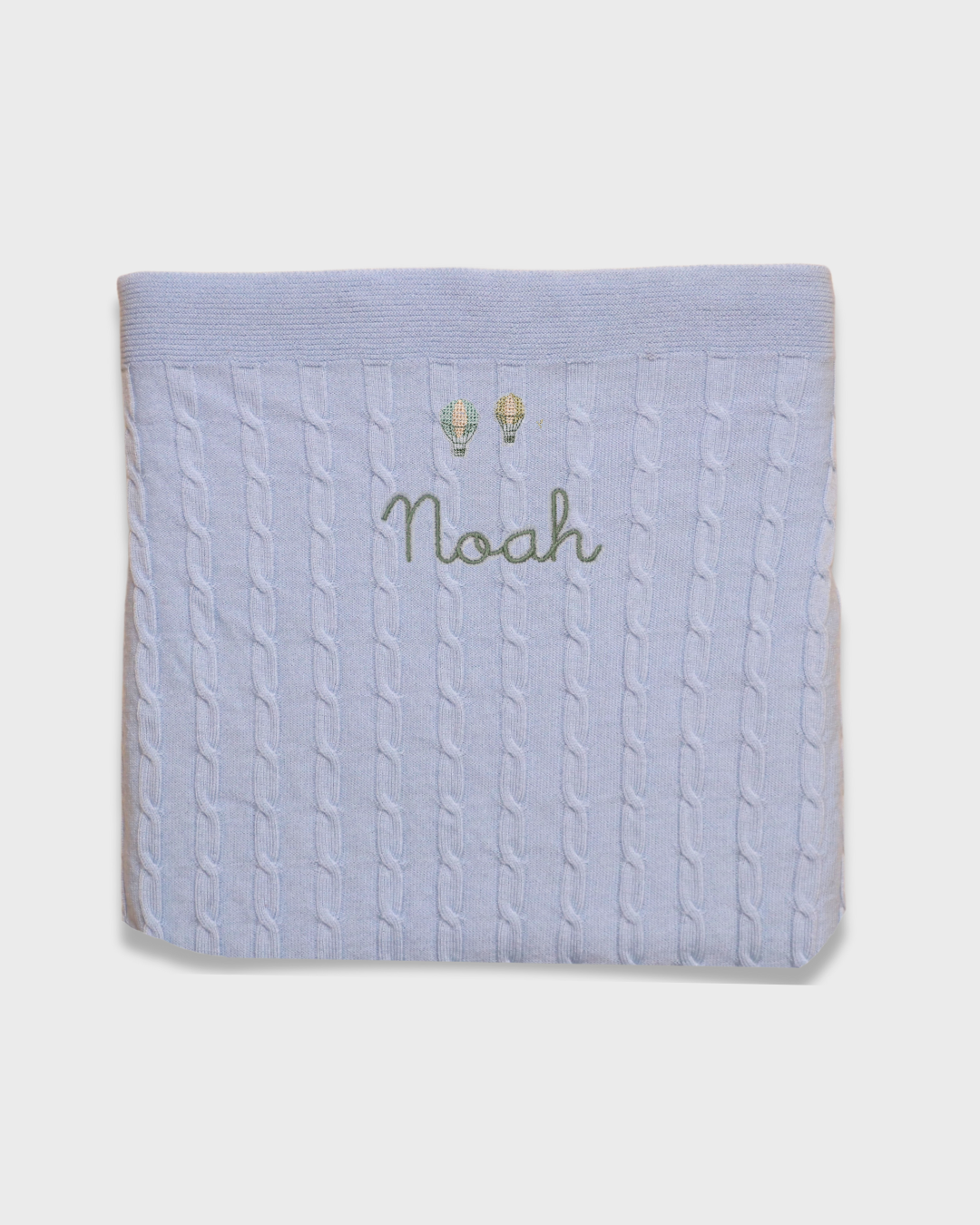Merino baby blanket with balloon design and personalized embroidery.
