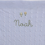 Merino wool baby blanket with balloons design and embroidered personalisation.