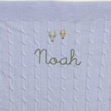 Merino wool baby blanket with balloons design and embroidered personalisation.