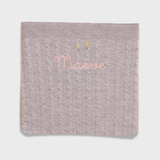 Merino baby blanket with embroidered hot air balloons design and personalized name.