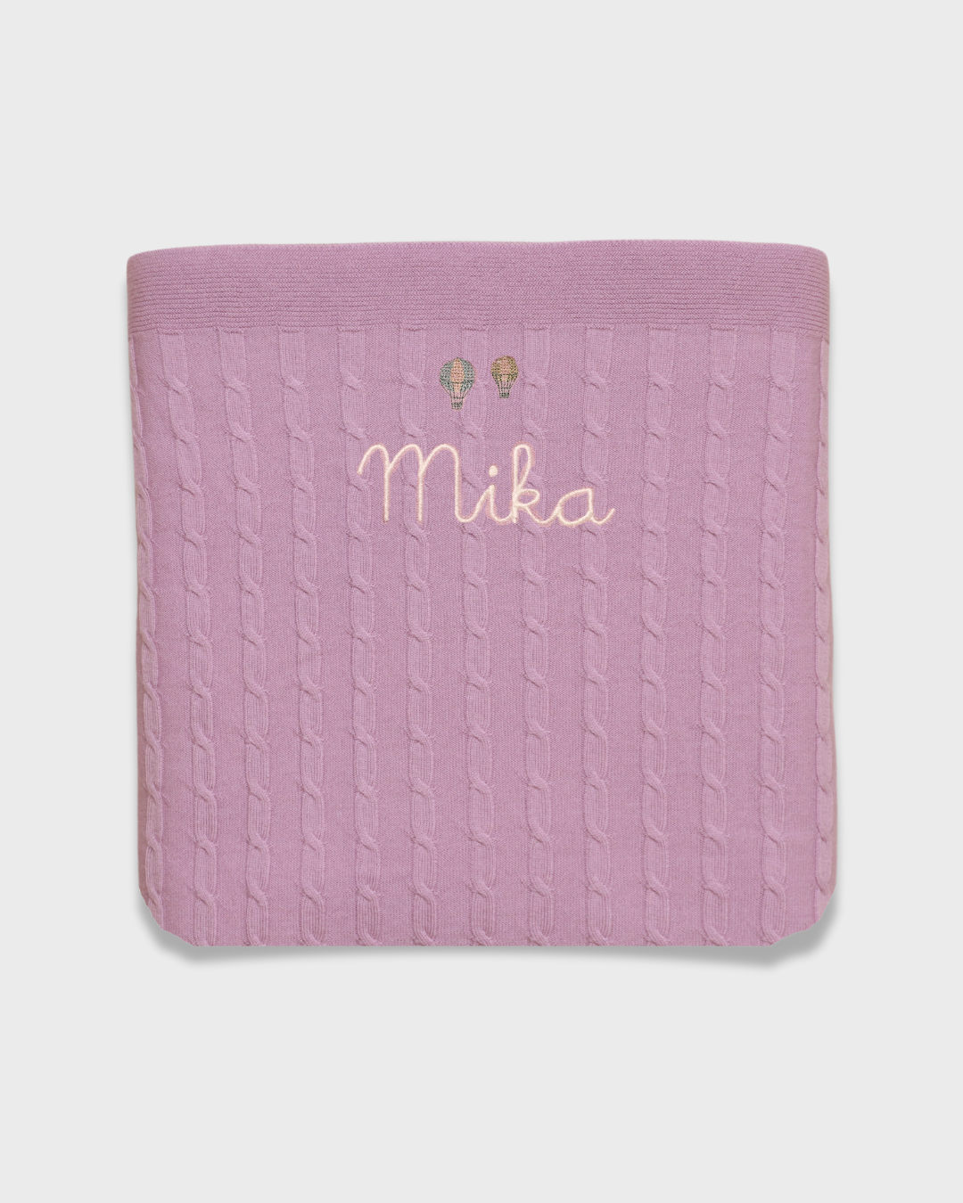 Merino baby blanket with balloon embroidery design and personalized name.