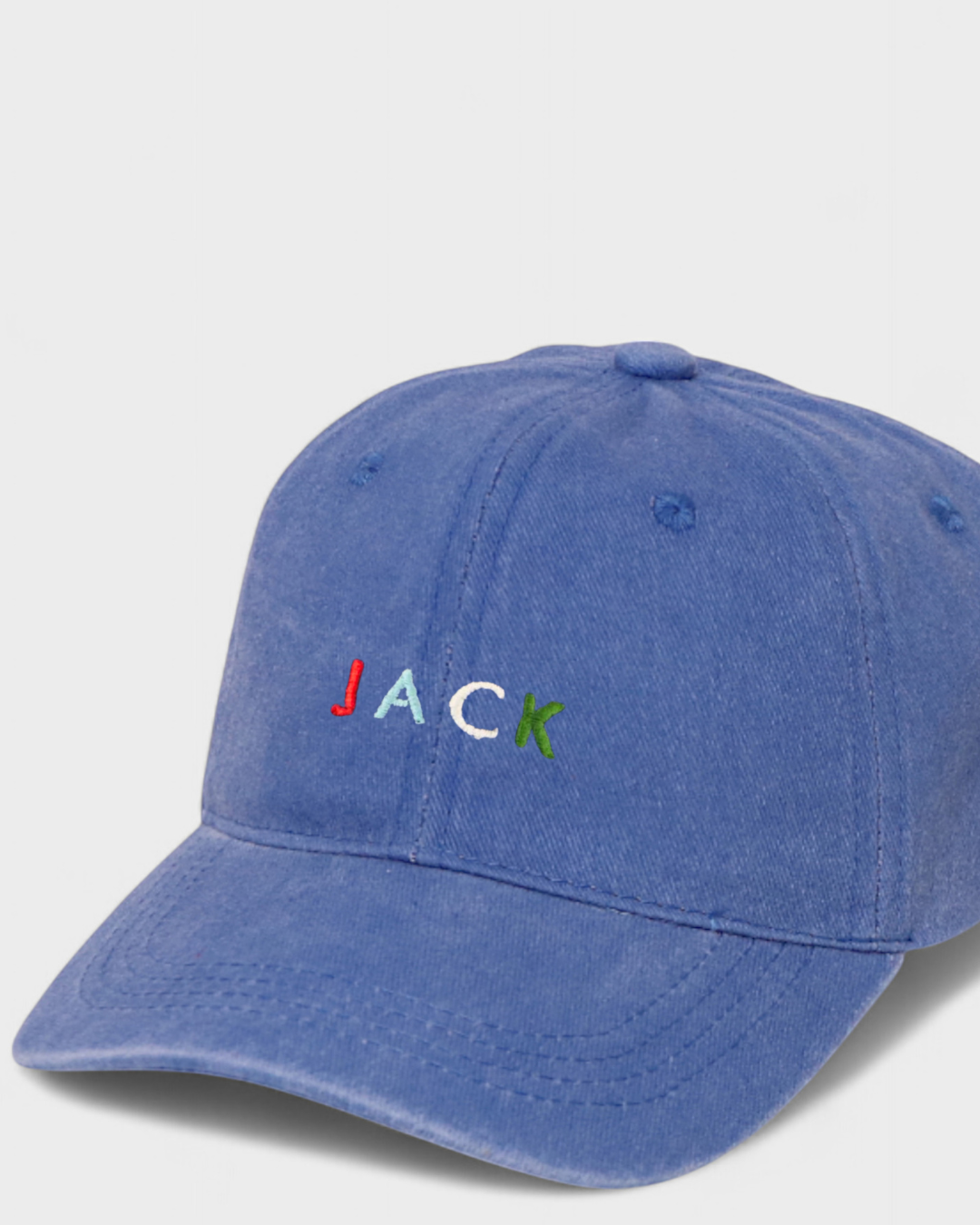 Personalised hat with multi-coloured embroidery on a blue cotton baseball cap.
