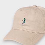 Beige personalised baseball hat with embroidered skier design, made of 100% washed cotton, available in kids and adult sizes.