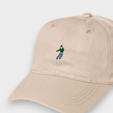 Beige personalised baseball hat with embroidered skier design, made of 100% washed cotton, available in kids and adult sizes.