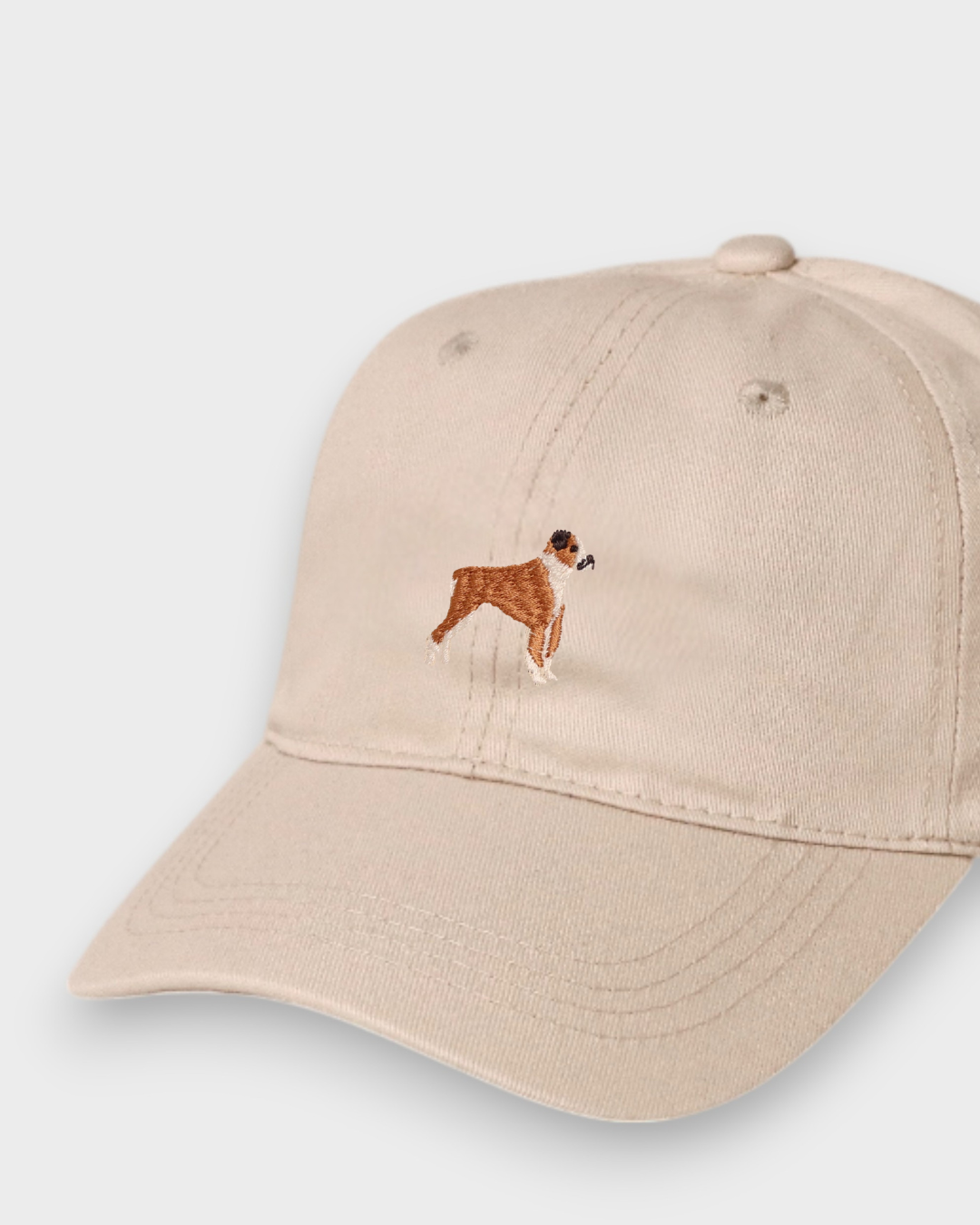Beige baseball cap with embroidered hand-drawn Boxer dog design, personalised embroidery option on back, made of 100% washed cotton.
