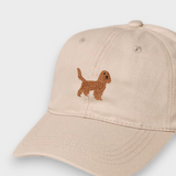Beige baseball cap with embroidered brown Cocker Spaniel design on the front, personalised embroidery option on the back, made of 100% washed cotton.