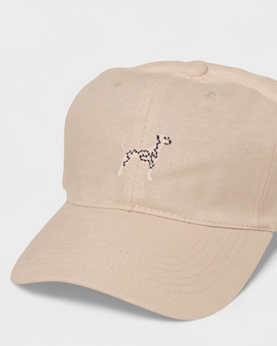 Dalmatian personalised hat with embroidered dog design on beige cotton.