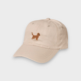 Beige baseball hat with embroidered brown Cocker Spaniel design on the front, made of 100% washed cotton, personalized embroidery option available.