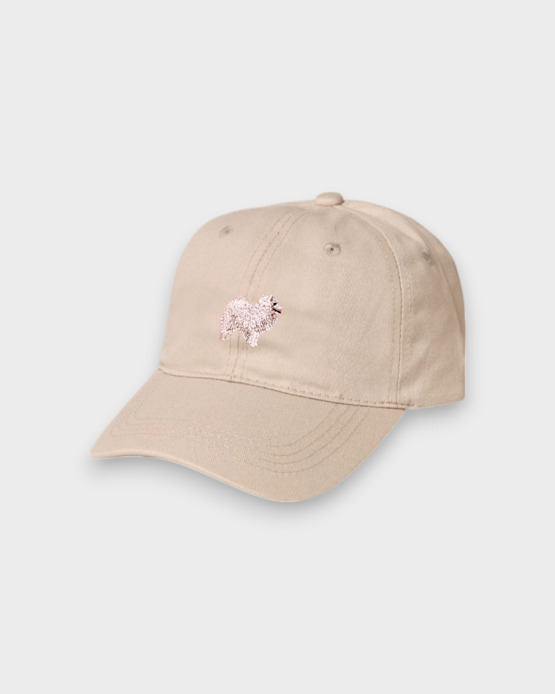 Beige baseball hat with embroidered Japanese Spitz design on front, customizable embroidery on back, made of 100% washed cotton.
