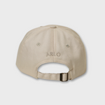 Beige Staffordshire Bull Terrier personalized baseball hat with custom embroidered name "Arlo" on the back.