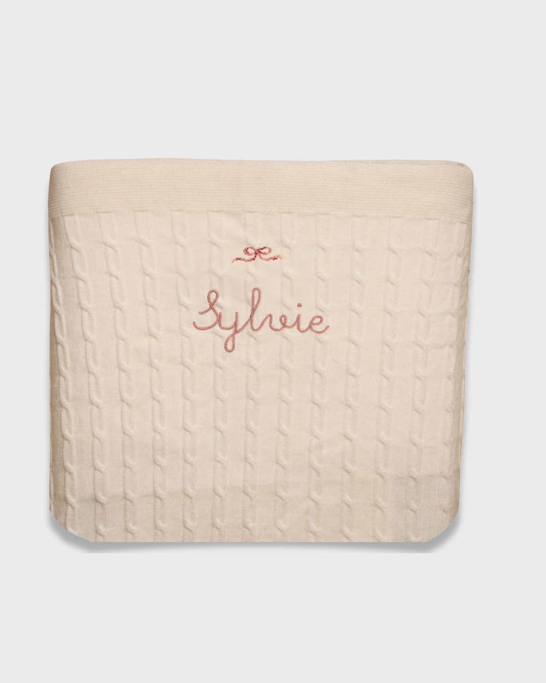 Merino baby blanket with bow design and personalized embroidery.