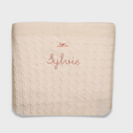 Merino baby blanket with bow design and personalized embroidery.