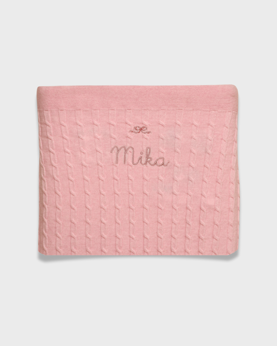 Merino baby blanket with bow design embroidery, soft and breathable wool.