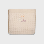 Cream merino baby blanket with embroidered moon, stars, and personalized name Mika