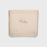 Cream merino baby blanket with embroidered moon, stars, and personalized name Mika