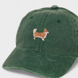Green cotton baseball cap with embroidered hand-drawn Corgi design on the front, personalized embroidery option on the back.
