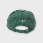 Green personalised hat with embroidered name "THEO" on the back, made of 100% washed cotton with adjustable strap.