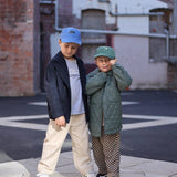 Children wearing personalised tennis hats with embroidery designs.