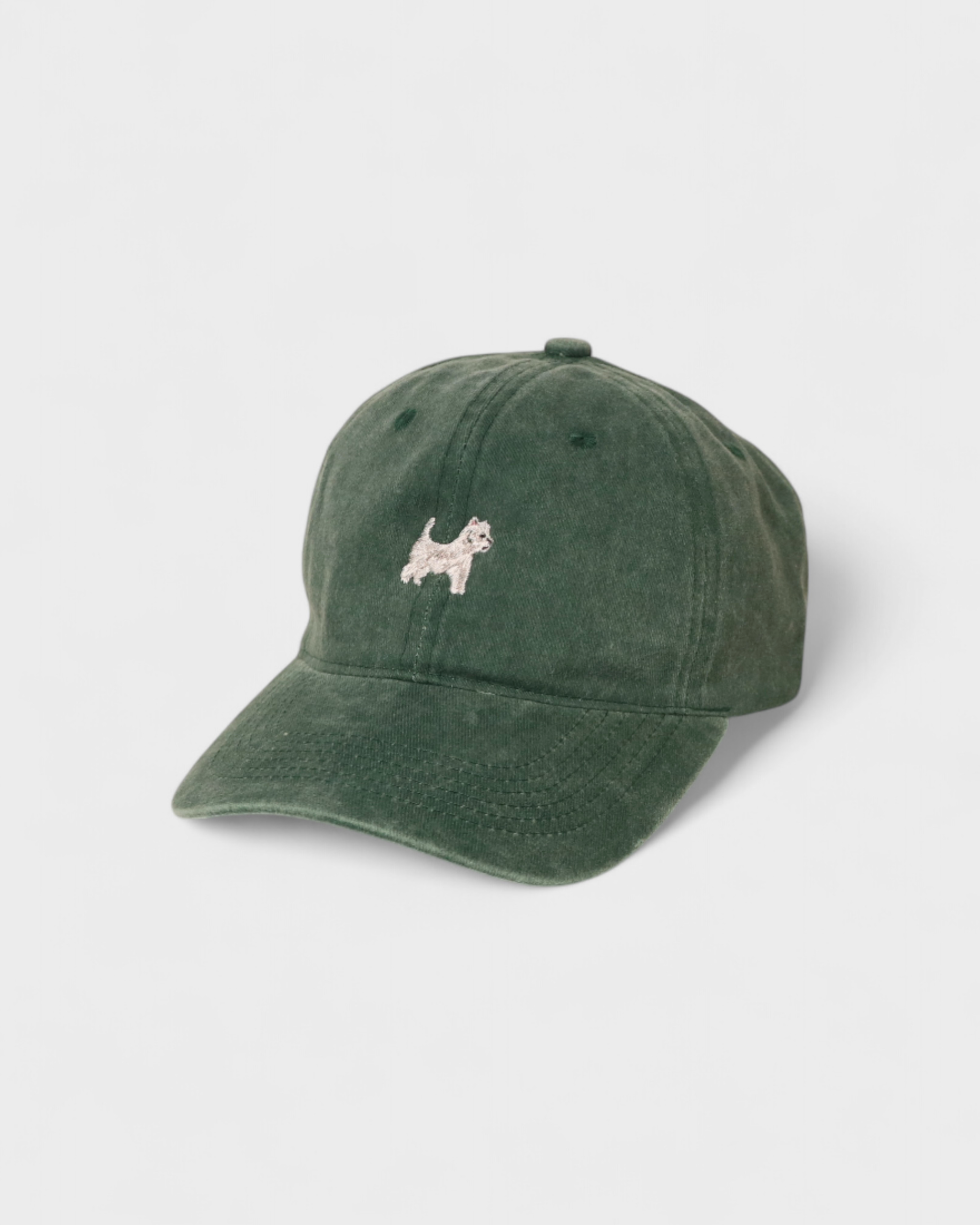 Westie White Terrier personalised hat with embroidered design on green cotton fabric.