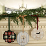 Custom pet ornaments with embroidered dog breeds and personalized names hanging with velvet ribbons on greenery decoration