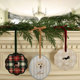 Custom pet ornaments with embroidered dog breeds and personalized names hanging with velvet ribbons on greenery decoration