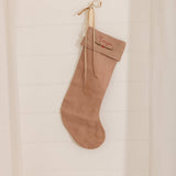  handmade personalized linen Christmas stocking in natural color hanging on wall
