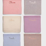 Merino Baby Blanket with personalized embroidery in various pastel colors.