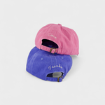 Airplane personalised hats in pink and blue with custom embroidered names, made of 100% washed cotton.