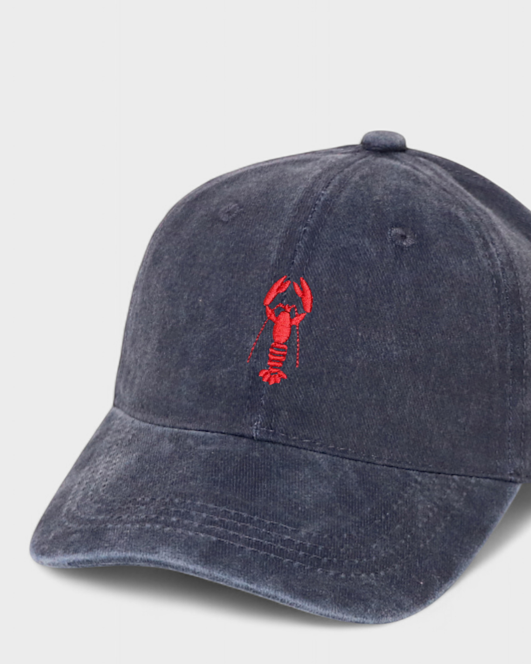 Navy blue personalised hat with red lobster embroidery and customisable back embroidery in block or script font