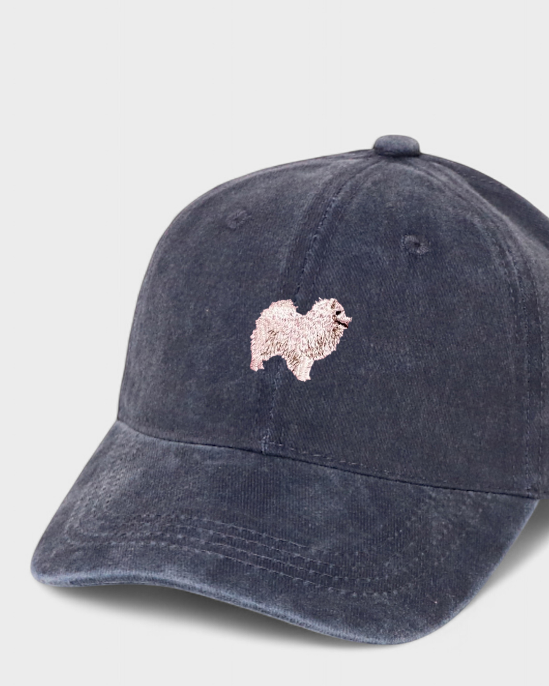 Navy Japanese Spitz personalised hat with embroidered dog design.