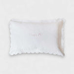 Organic cotton pillowcase with white scalloped edge and personalized embroidery.