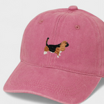 Pink baseball hat with embroidered Basset Hound design on front, personalised embroidery option on back, made of 100% washed cotton.